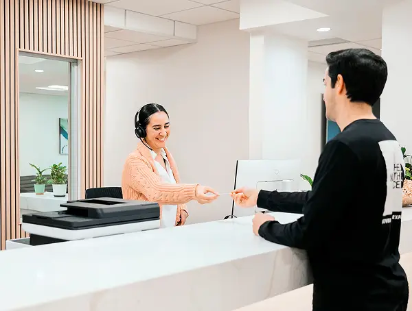 Patient checking in with the front desk staff at Retina Vision Consultants