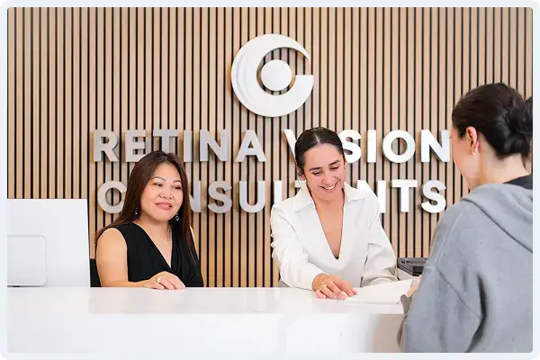 Front desk staff assisting a patient at Retina Vision Consultants
